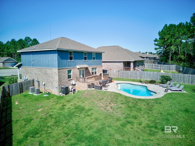 rear view of house featuring a patio, a yard, central air condition unit, and a fenced in pool