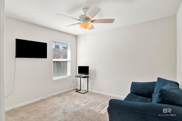 sitting room featuring ceiling fan and light colored carpet