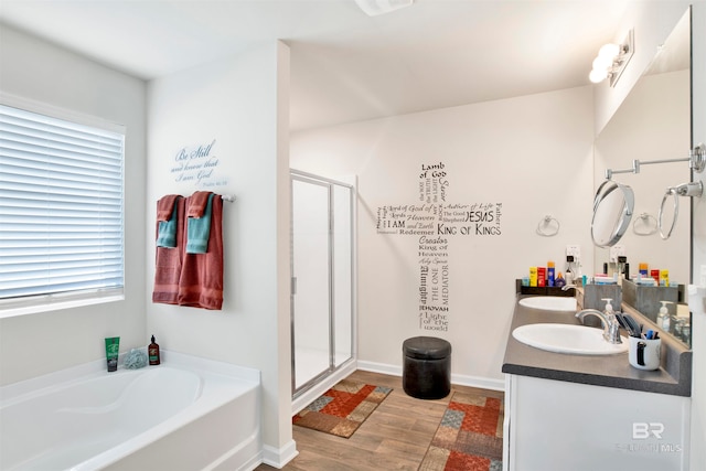 bathroom with hardwood / wood-style floors, vanity, and shower with separate bathtub