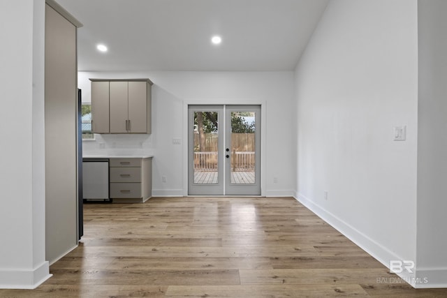 unfurnished dining area with recessed lighting, french doors, baseboards, and light wood finished floors