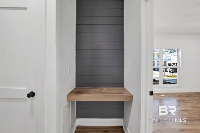 mudroom with baseboards and wood finished floors