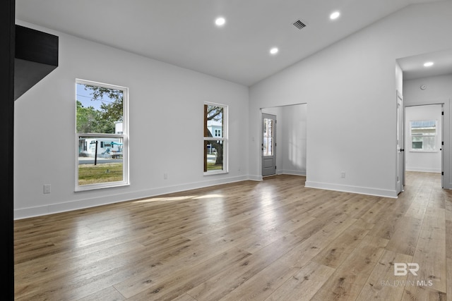 spare room with vaulted ceiling, light wood finished floors, and recessed lighting