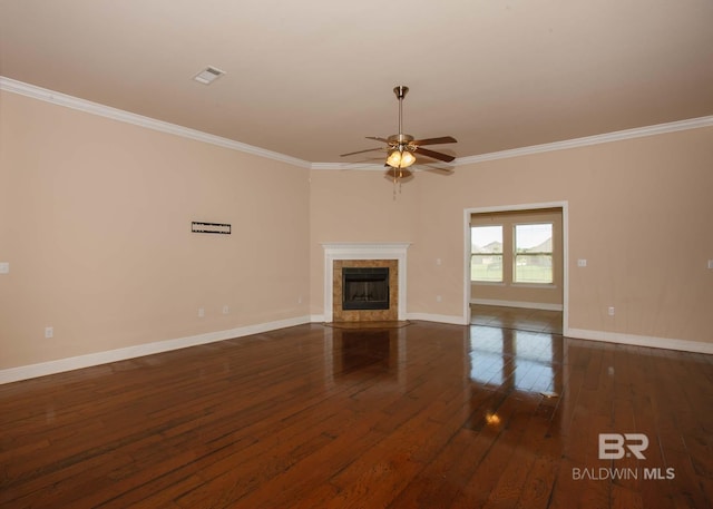 unfurnished living room featuring a tile fireplace, crown molding, ceiling fan, and dark hardwood / wood-style flooring