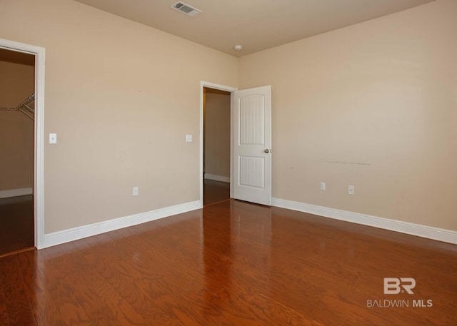 empty room with dark hardwood / wood-style floors