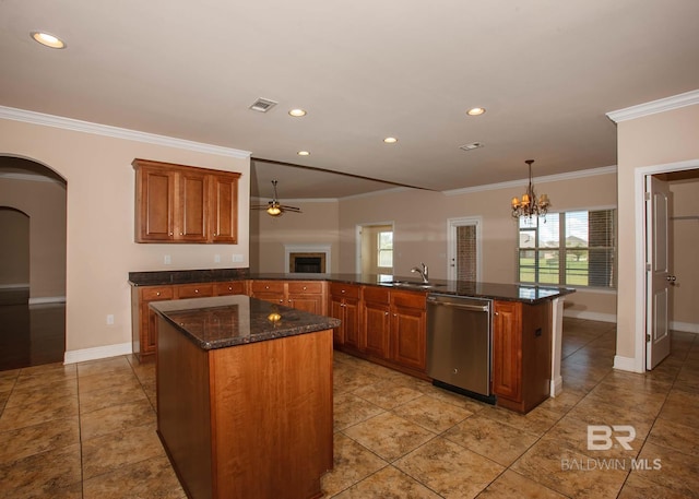 kitchen featuring sink, hanging light fixtures, stainless steel dishwasher, kitchen peninsula, and a center island with sink