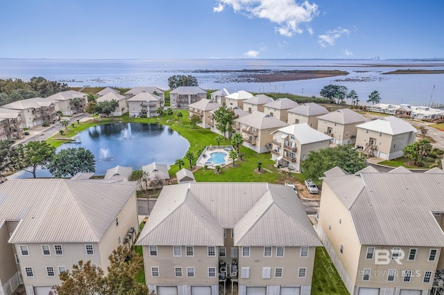 drone / aerial view featuring a water view and a residential view