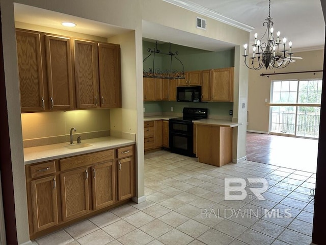 kitchen with visible vents, light countertops, crown molding, black appliances, and a sink