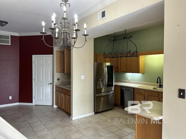 kitchen with crown molding, visible vents, a sink, stainless steel fridge, and dishwashing machine