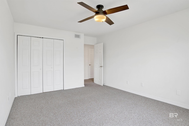 unfurnished bedroom with visible vents, a ceiling fan, a closet, carpet flooring, and baseboards