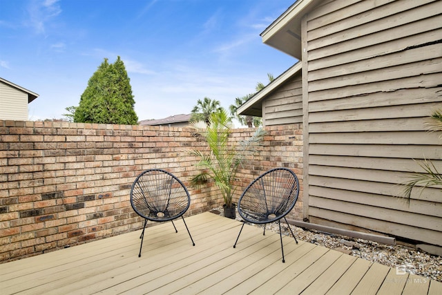 wooden terrace featuring fence