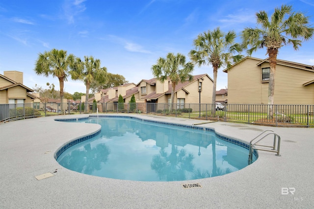 view of pool featuring fence, a fenced in pool, and a residential view