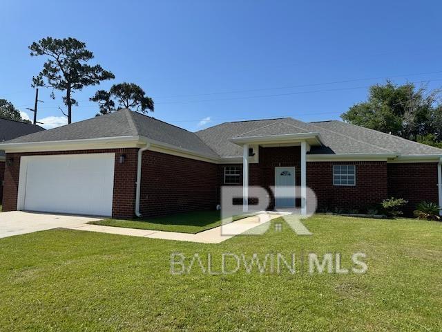 16825 Edward Dr, Gulf Shores, AL 36542 - ranch-style house featuring brick siding, a garage, a front lawn, and driveway