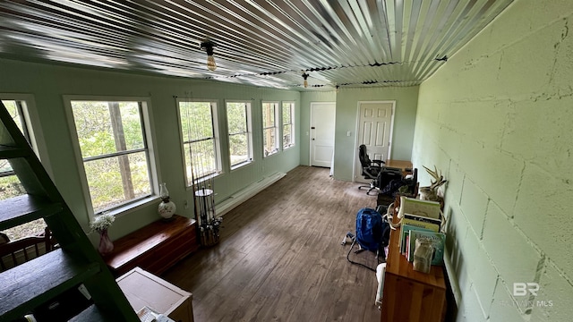 sunroom with baseboard heating and a healthy amount of sunlight