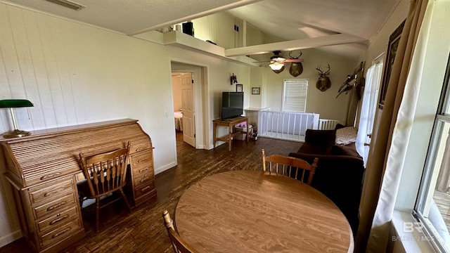 dining room featuring dark hardwood / wood-style floors, vaulted ceiling, and ceiling fan