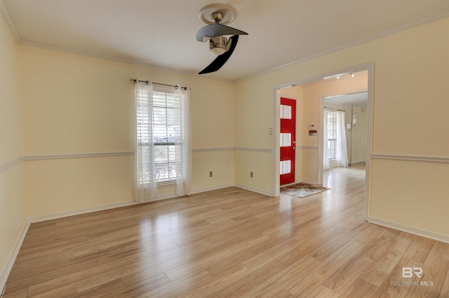 empty room with ornamental molding and light hardwood / wood-style flooring