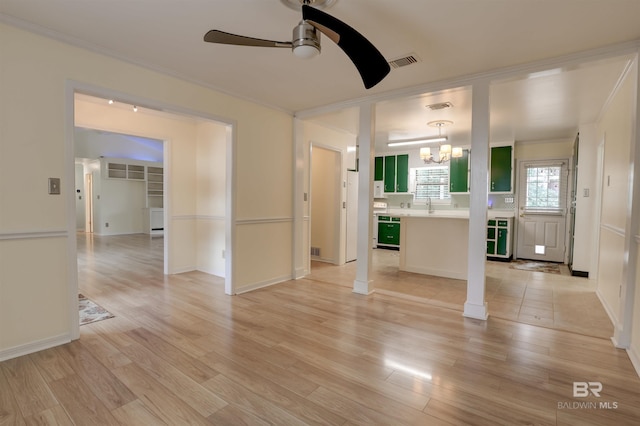 interior space featuring crown molding, sink, ceiling fan with notable chandelier, and light wood-type flooring