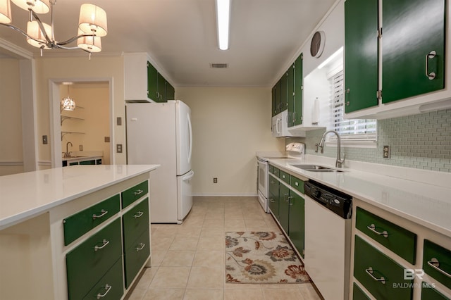 kitchen with sink, white appliances, hanging light fixtures, and green cabinets