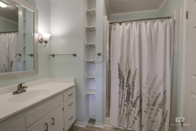 bathroom with ornamental molding, curtained shower, and vanity