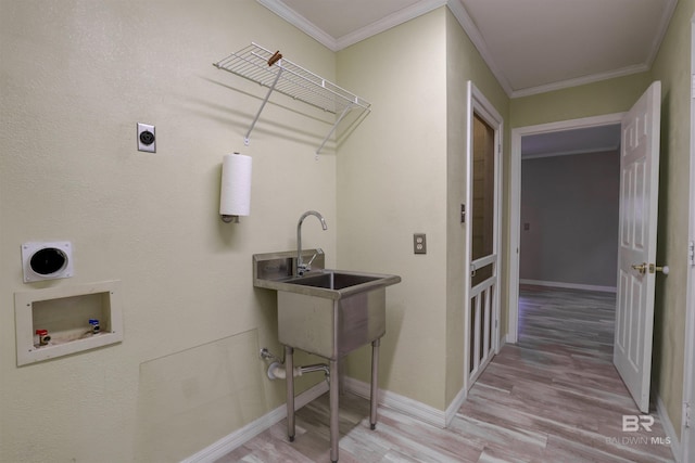 washroom with crown molding, electric dryer hookup, washer hookup, and light hardwood / wood-style floors