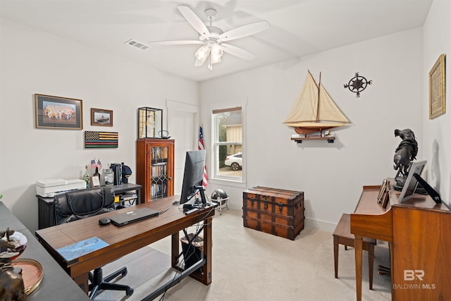 office area with light colored carpet and ceiling fan