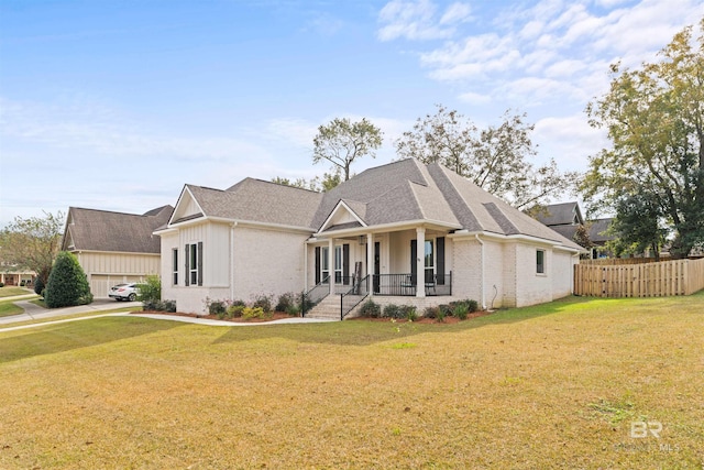 view of front of property featuring covered porch and a front lawn