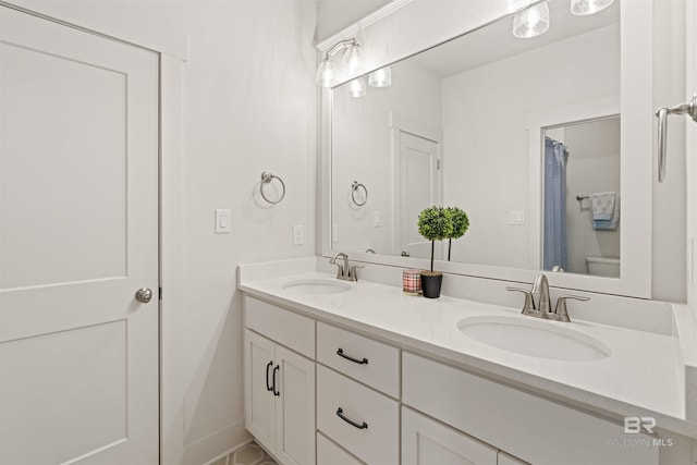 bathroom featuring vanity and toilet