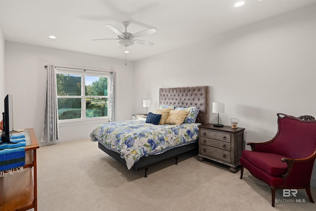 bedroom with light carpet and ceiling fan