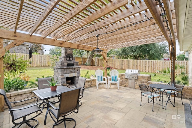 view of patio / terrace with an outdoor stone fireplace, area for grilling, a pergola, and an outdoor kitchen