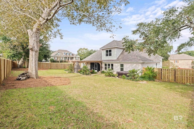 back of house featuring a yard