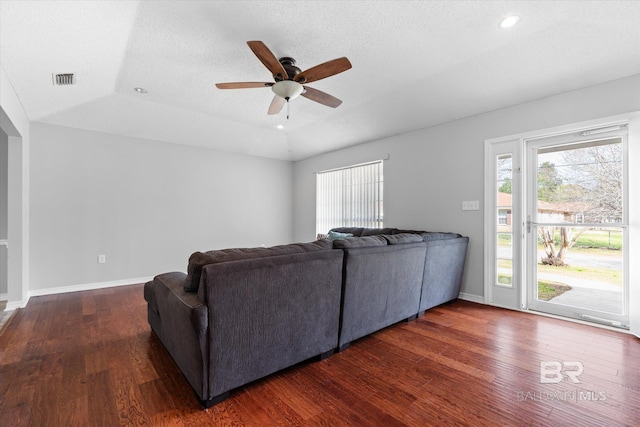 living room with lofted ceiling, wood finished floors, a ceiling fan, and baseboards