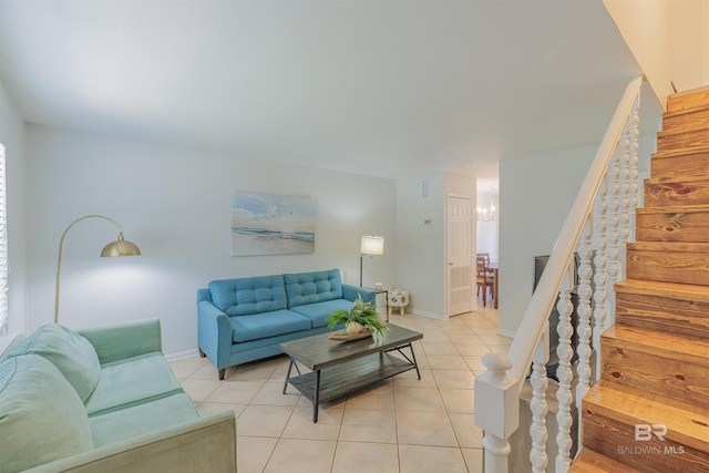 living area with stairway, baseboards, and light tile patterned floors