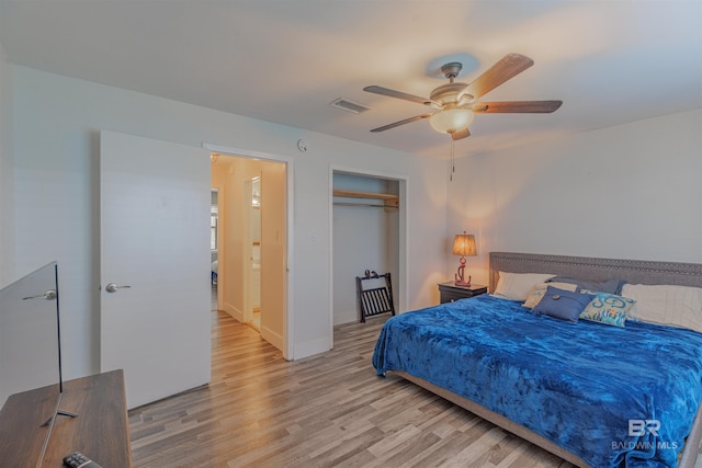 bedroom with a closet, visible vents, light wood-style flooring, ceiling fan, and baseboards