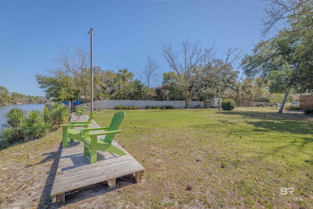 view of yard with a water view and fence