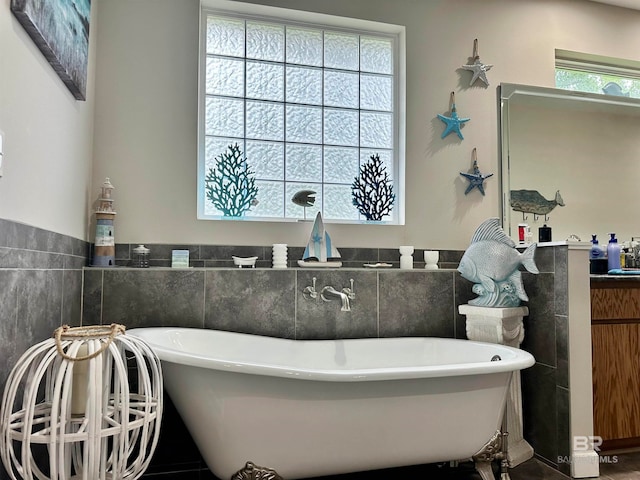 bathroom with tile walls and a washtub