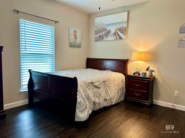 bedroom with dark wood-type flooring