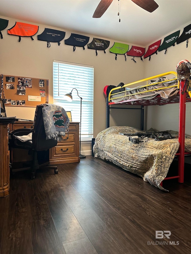 bedroom with dark hardwood / wood-style flooring and ceiling fan