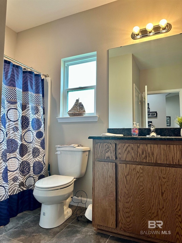 bathroom featuring tile patterned flooring, vanity, and toilet