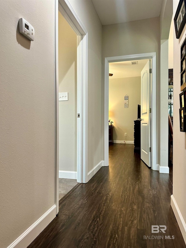 corridor featuring dark hardwood / wood-style floors