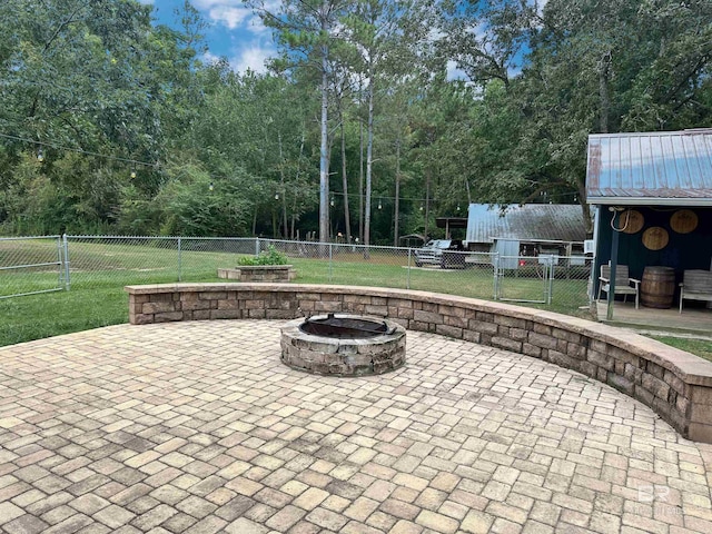 view of patio / terrace featuring an outdoor fire pit