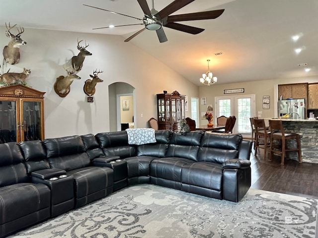 living room featuring ceiling fan with notable chandelier, lofted ceiling, and hardwood / wood-style floors