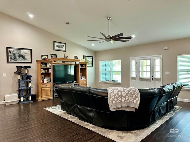 living room featuring vaulted ceiling, dark wood-type flooring, ceiling fan, and plenty of natural light