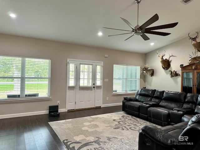 living room with ceiling fan and dark hardwood / wood-style flooring