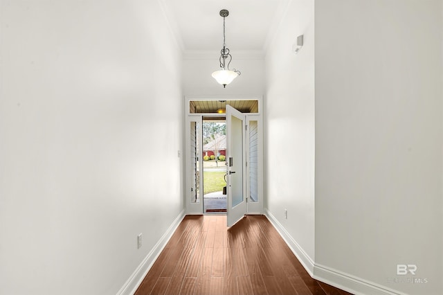 entryway with baseboards, dark wood finished floors, and ornamental molding