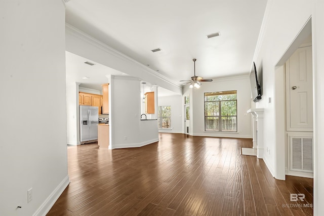 unfurnished living room with dark wood finished floors, visible vents, and crown molding