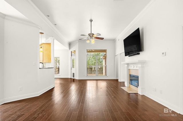 unfurnished living room featuring baseboards, a fireplace, wood-type flooring, and crown molding