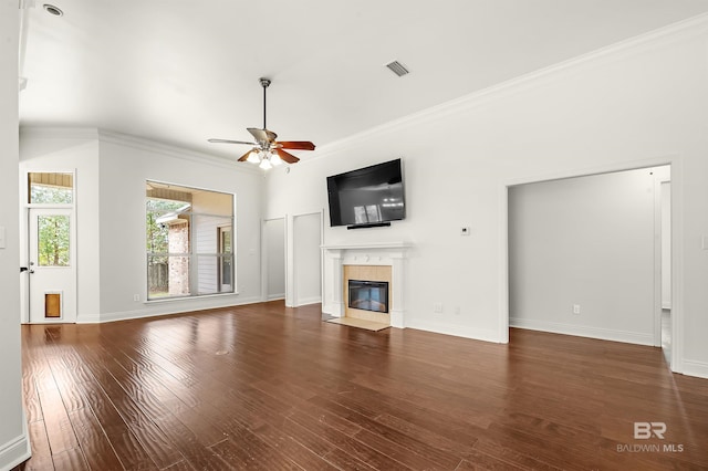 unfurnished living room with a premium fireplace, wood finished floors, visible vents, baseboards, and crown molding