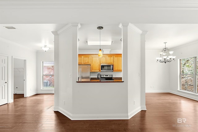 kitchen with baseboards, appliances with stainless steel finishes, dark countertops, dark wood finished floors, and crown molding