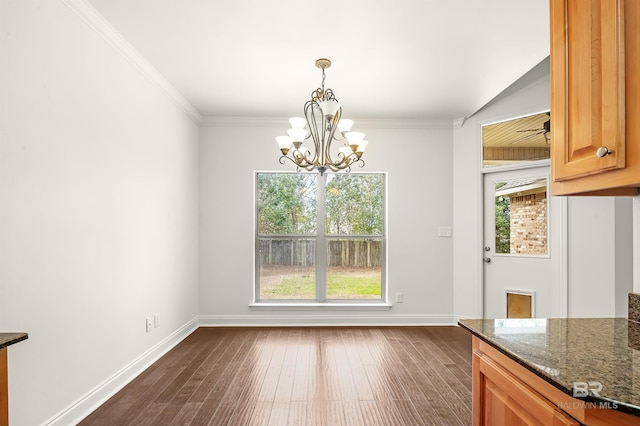 unfurnished dining area with baseboards, ornamental molding, and dark wood-type flooring