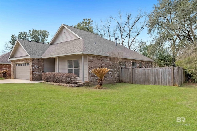 view of home's exterior featuring a shingled roof, fence, a lawn, and brick siding