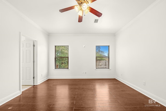 unfurnished room with crown molding, dark wood-style flooring, baseboards, and a healthy amount of sunlight